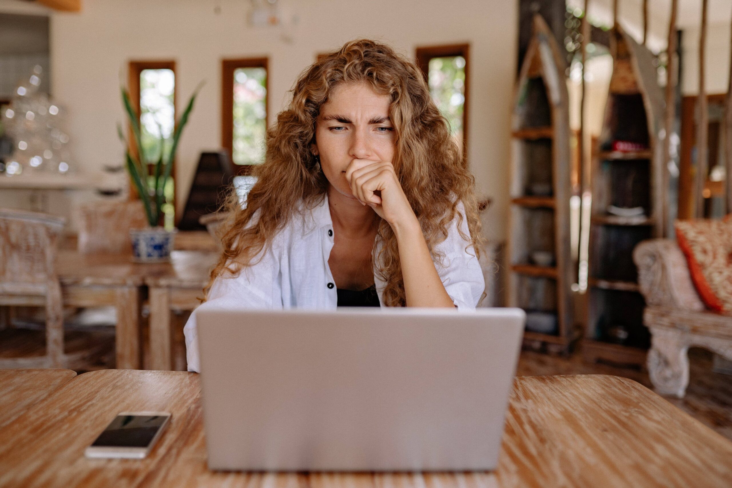 Woman thinking while looking at her computer