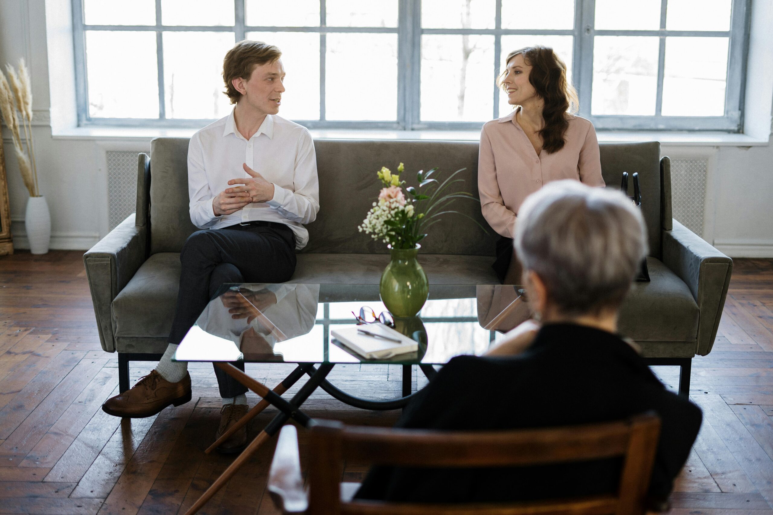 couple sitting on couch across from therapist