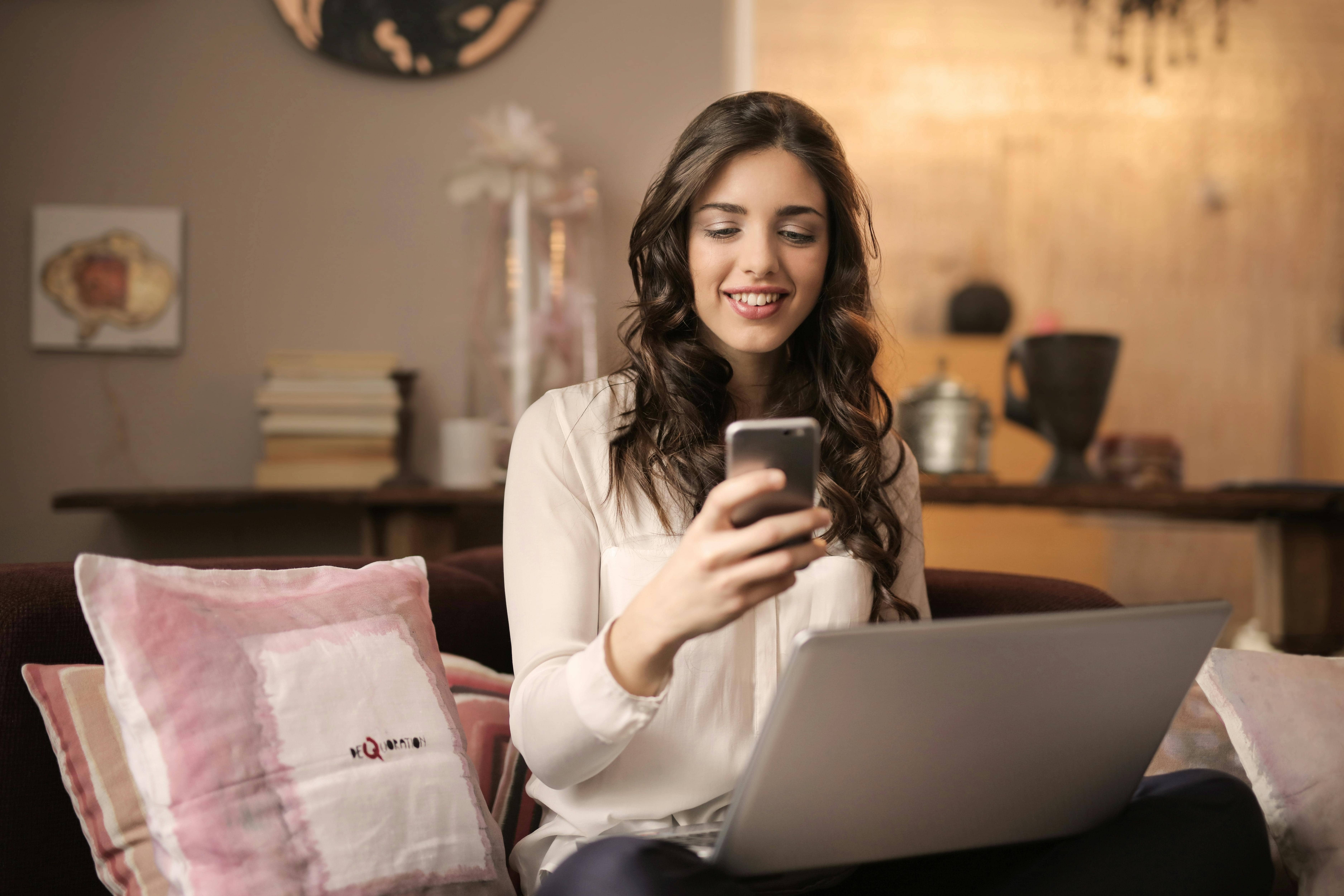 Nashville woman smiling while looking at phone to represent managing election anxiety